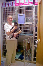 Staff member holding a dog in the hospital ward